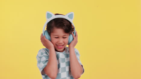 boy listening to music with cat ear headphones
