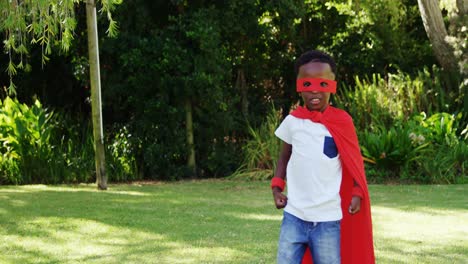 little boy posing in costume of superhero