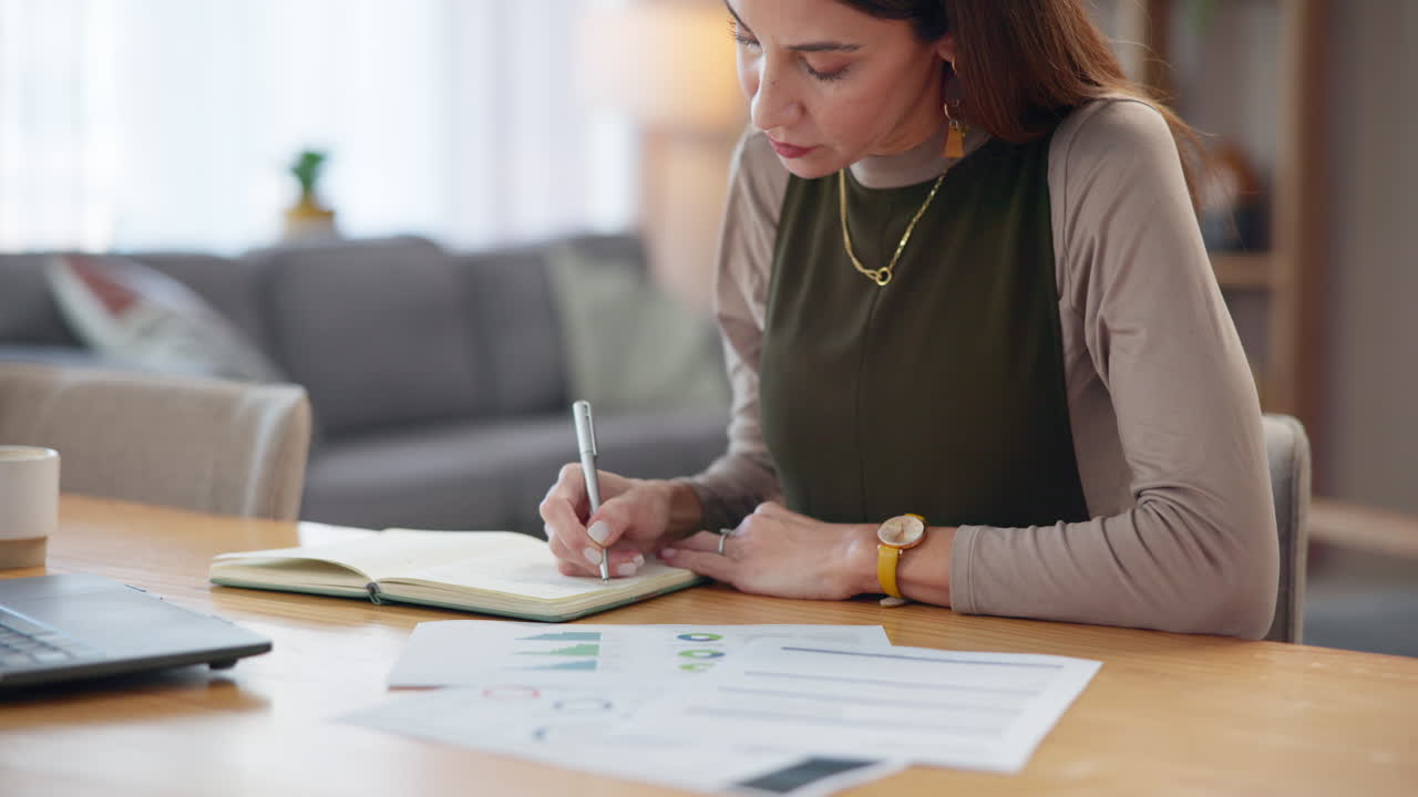 Mujer escribiendo en un cuaderno en su escritorio