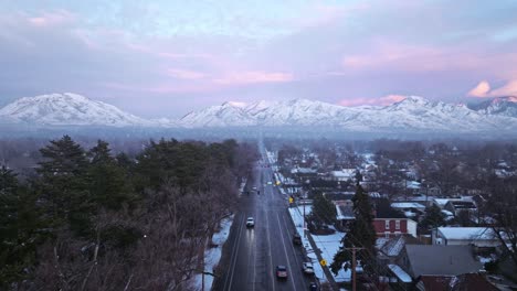 cold icy side road leads straight to epic snow covered mountain ridgelines of the wasatch in salt lake city