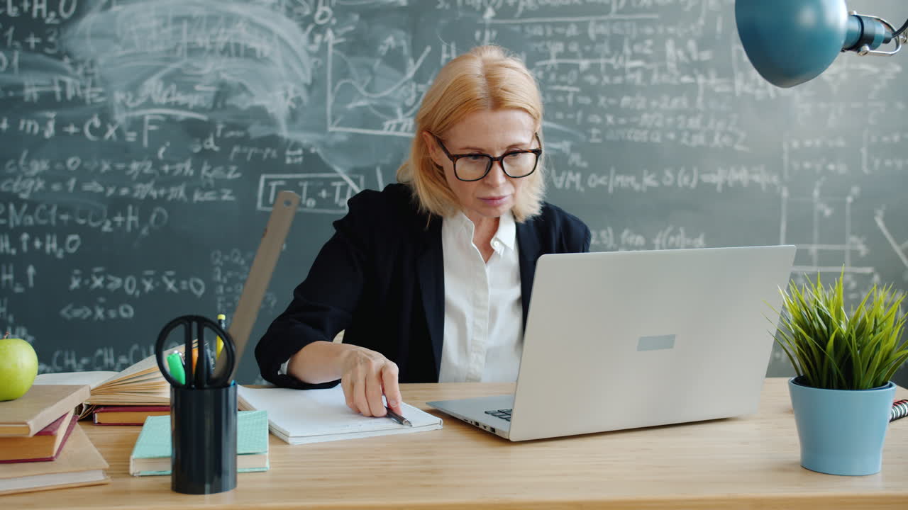 Teacher taking notes during an online class