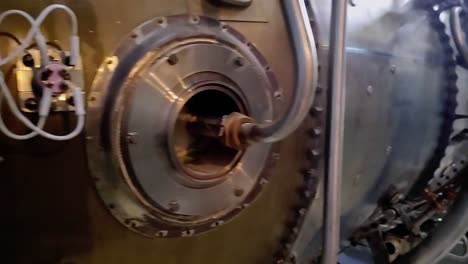 soviet aircraft engine d30, hanging on a chain hoist. jet engine repair. maintenance of the turbojet engine. close-up