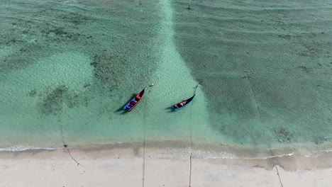 Sandy-beach,-ocean-water-ripple,-traditional-fishing-boats,-horizon-reveal