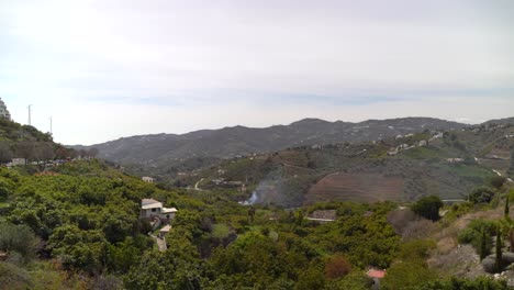 Rural-Mediterranean-countryside-scenery-with-green-hills-and-small-fire