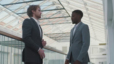 two male business partners shaking hands