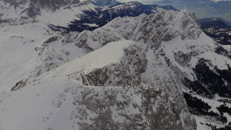 Breathtaking-aerial-view-of-snow-covered-Dolomite-mountain-peaks-in-Sass-de-Putia,-Italy