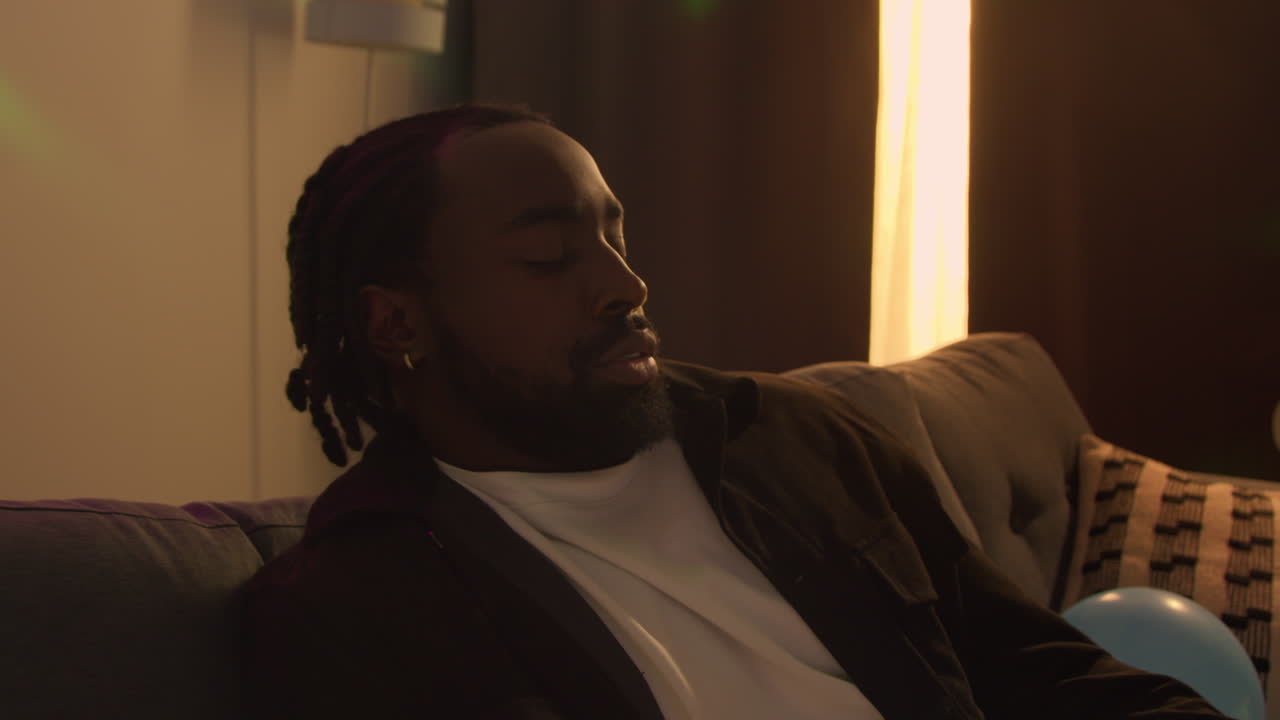Man Sitting By Sofa At House Party Deciding He Has Had Enough Alcohol To Drink 3