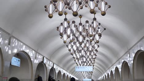 this vibrant exploration showcases the stunning architecture of moscow's metro stations, bustling with life as people navigate the beautiful corridors and stunning chandeliers.
