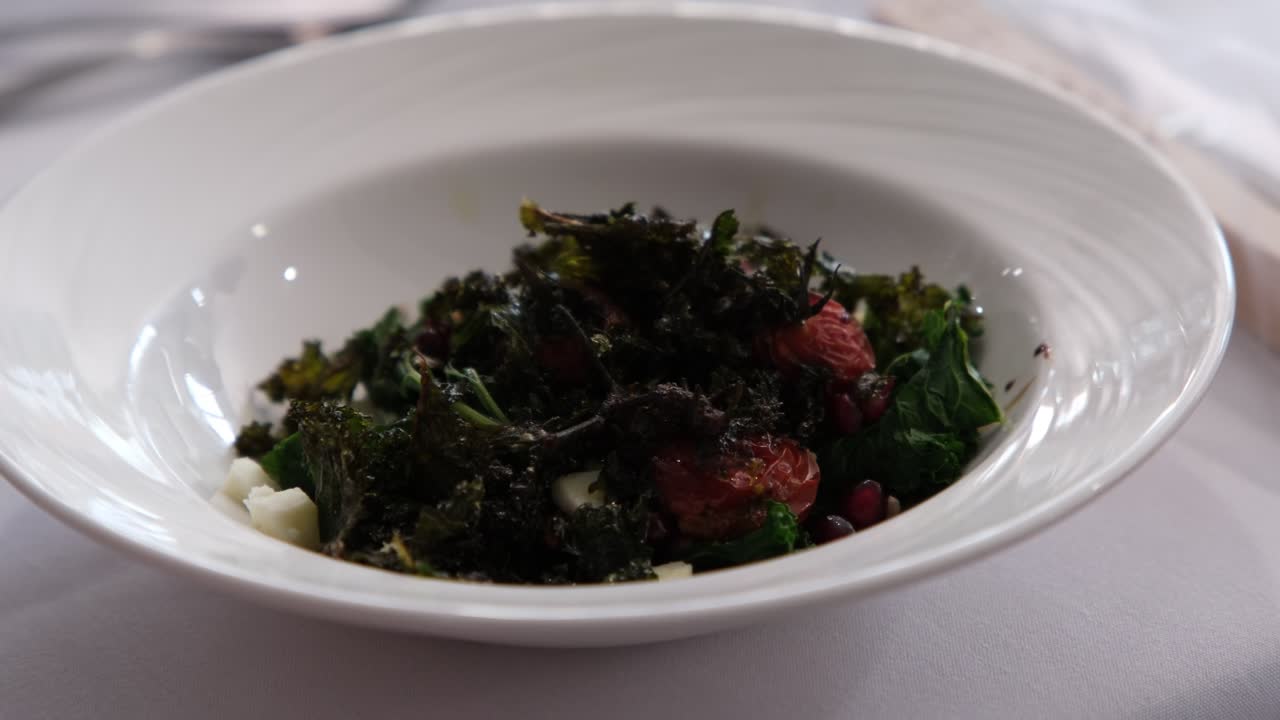 Vibrant wedding salad beautifully served on a white plate, featuring fresh greens and colourful vegetables. Ideal for illustrating elegant catering, healthy dining, or festive wedding receptions