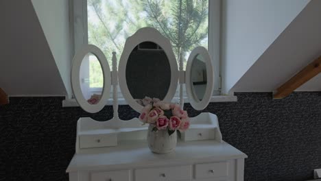 Side-dolly-shot-of-an-oldstyle-threesided-open-rounded-mirror