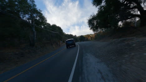 Black-car-driving-fast-on-road