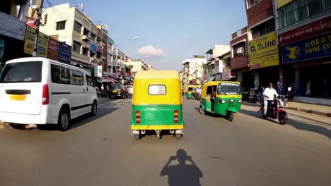 busy indian city street with auto rickshaws