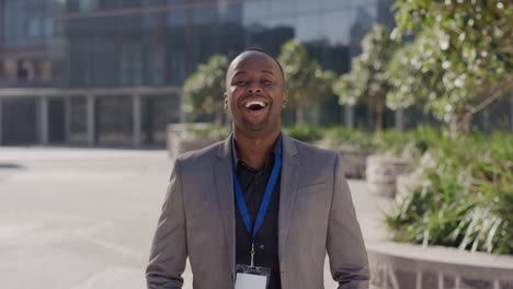 portrait young successful african american businessman laughing arms crossed enjoying professional urban lifestyle in city ambitious black entrepreneur looking confident