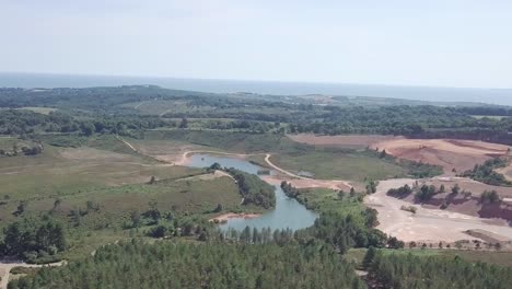 Aerial-view-of-a-lake-and-quarry-in-Woodbury-England