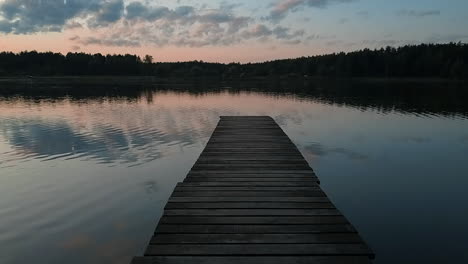 a narrow wooden pier over a lake