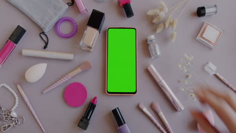 woman's makeup and phone flat lay