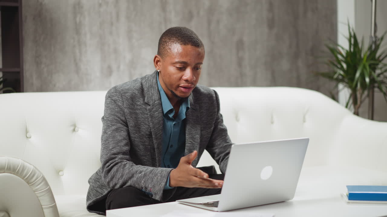 Black manager communicates with colleagues at videocall