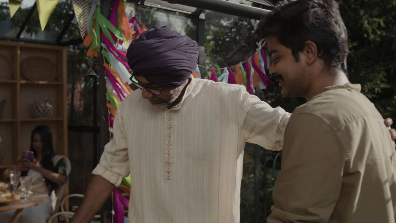 A man receives a thoughtful gift at a lively garden celebration