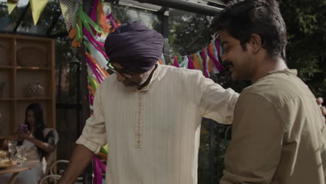a man receives a thoughtful gift at a lively garden celebration