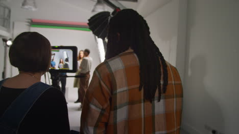 actors rehearsing with director shooting movie or video in studio with sound and camera film crew 2