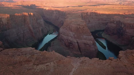 rocky cliff edge above horseshoe bend,sunrise,colorado river,arizona