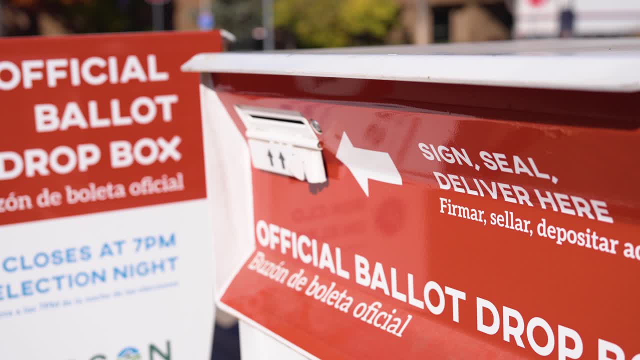 Close shot of a ballot drop box with official voting signage, showing election infrastructure, ballot submission, and civic participation