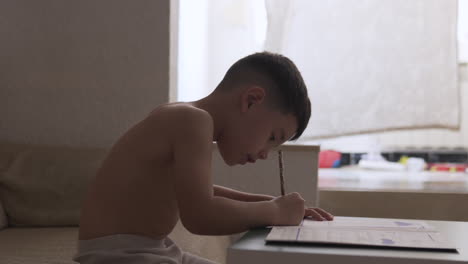 kid practicing and learning to write during summer vacation at home