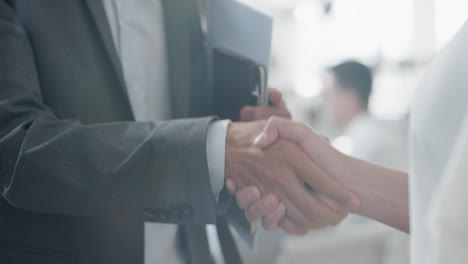 close-up-business-people-shaking-hands--corporate-partnership-deal-welcoming-opportunity-for-cooperation-in-office