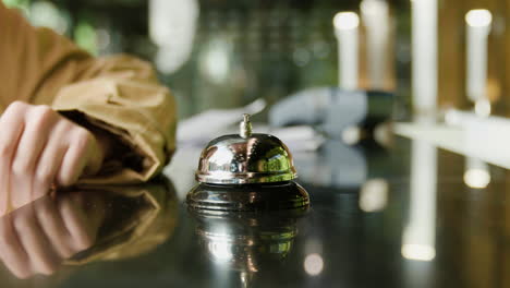 finger of a host pressing the reception bell