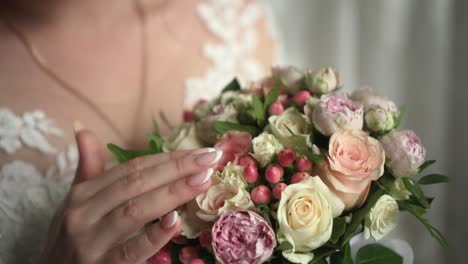 the bride holds a wedding bouquet in her hands 02