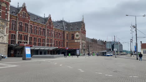 still shot of the front of amsterdam central station during the coronavirus pandemic in the netherlands