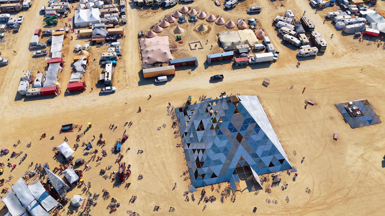 Nevada, USA, 25 August 2025: Drone shot from above showing the geometric pyramid installation and surrounding desert camp layout at the Burning Man festival