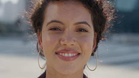 portrait beautiful young hispanic business woman smiling running hand tghrough hair enjoying successful urban lifestyle in city wearing stylish earings