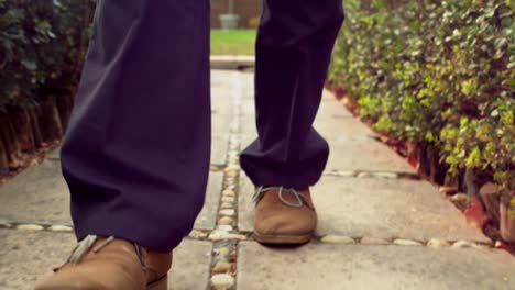 Man-walking-on-a-pavement