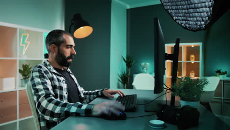 blogger using desktop computer mouse and keyboard to write a post for social media