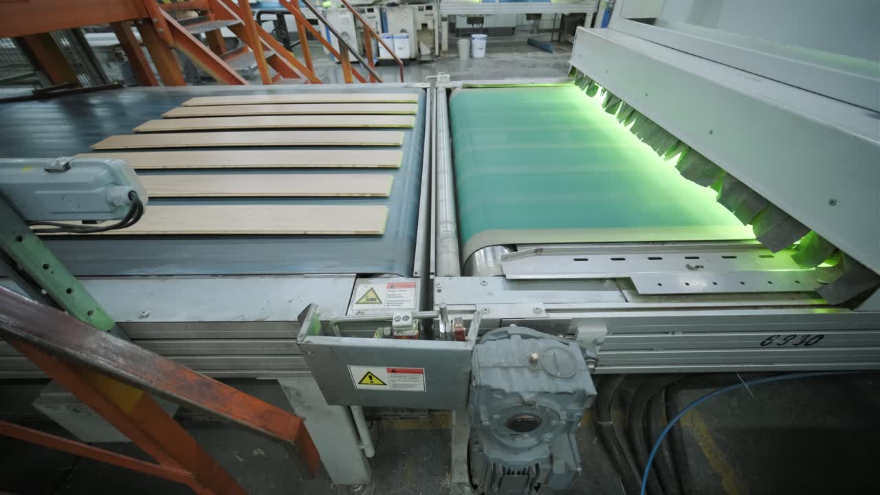 Wooden Planks Moving Through Automated Industrial Processing Machine