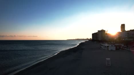 Aerial-view-over-the-beautiful-mediterranean-coastline-of-Fuengirola,-in-Malaga,-Spain-during-sunset