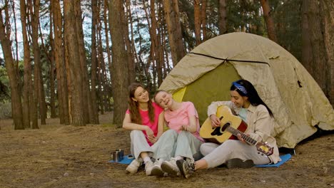 friends camping and playing guitar