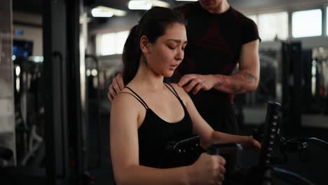 woman working out with a personal trainer in a gym