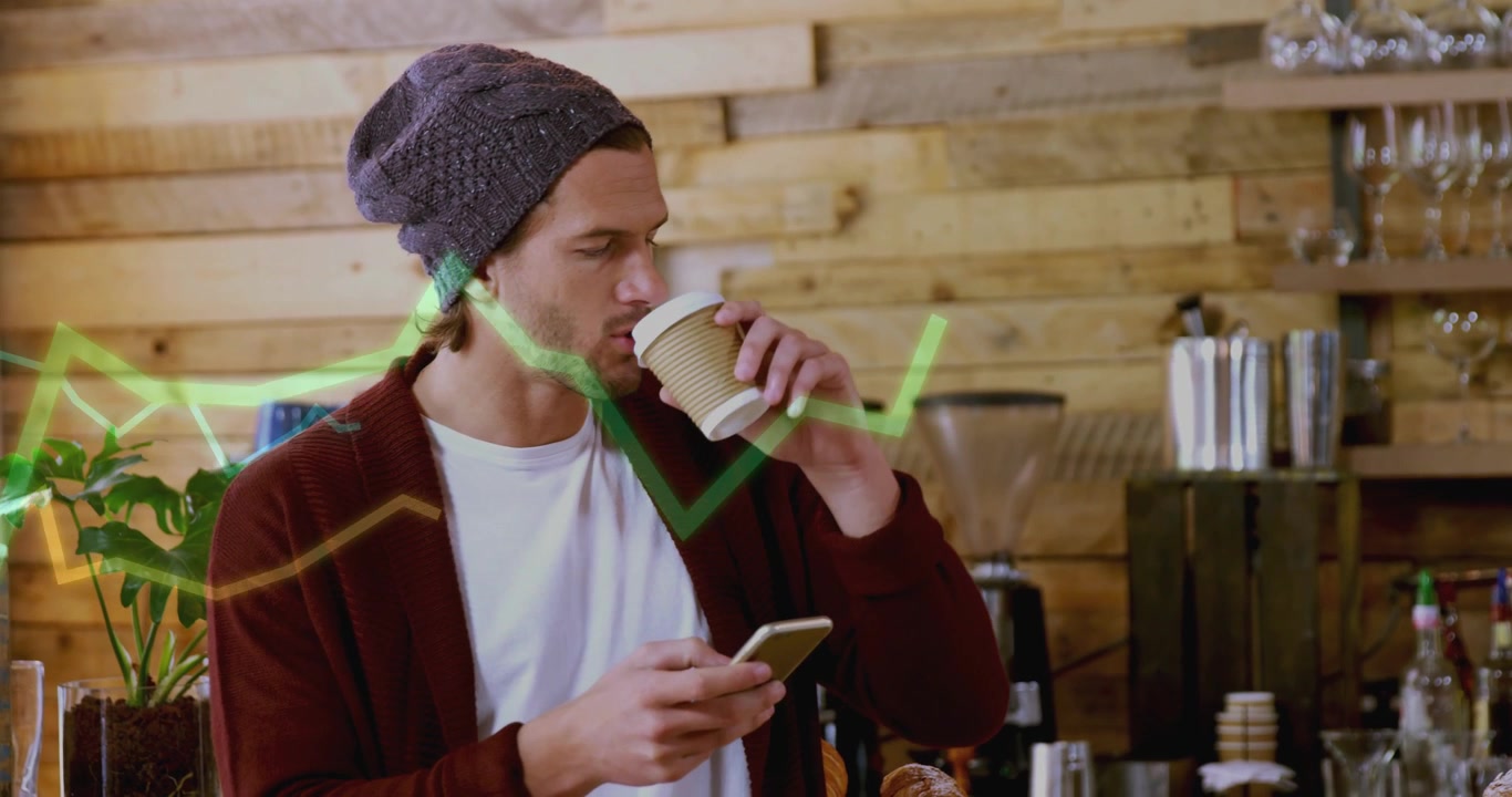 Man tapping phone while sipping coffee in cafe, moving green chart crossing face showing analytics