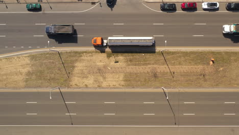 a top down view directly over a highway median on a sunny day