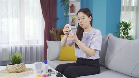 asian teenage girl running out of care cream is upset.