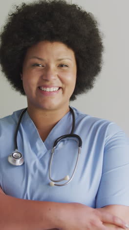 video of happy plus size african american female doctor looking at camera