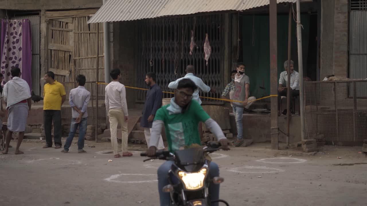 Crowds outside a butcher shop in India practicing social distancing