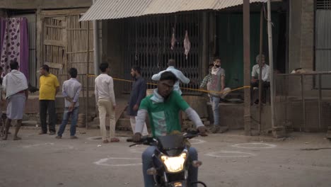 crowds outside a butcher shop in india practicing social distancing