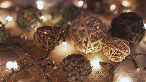 close-up christmas garland and handmade balls on a playd with golden lights. christmas concept. home decor