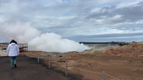 woman's epic walk by gunnuhver volcanic area in south iceland