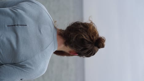 vertical view of a man rear looking at the calm sea