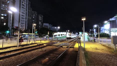 busy mtr light rail with many night-time travelers, tin shui wai, time lapse