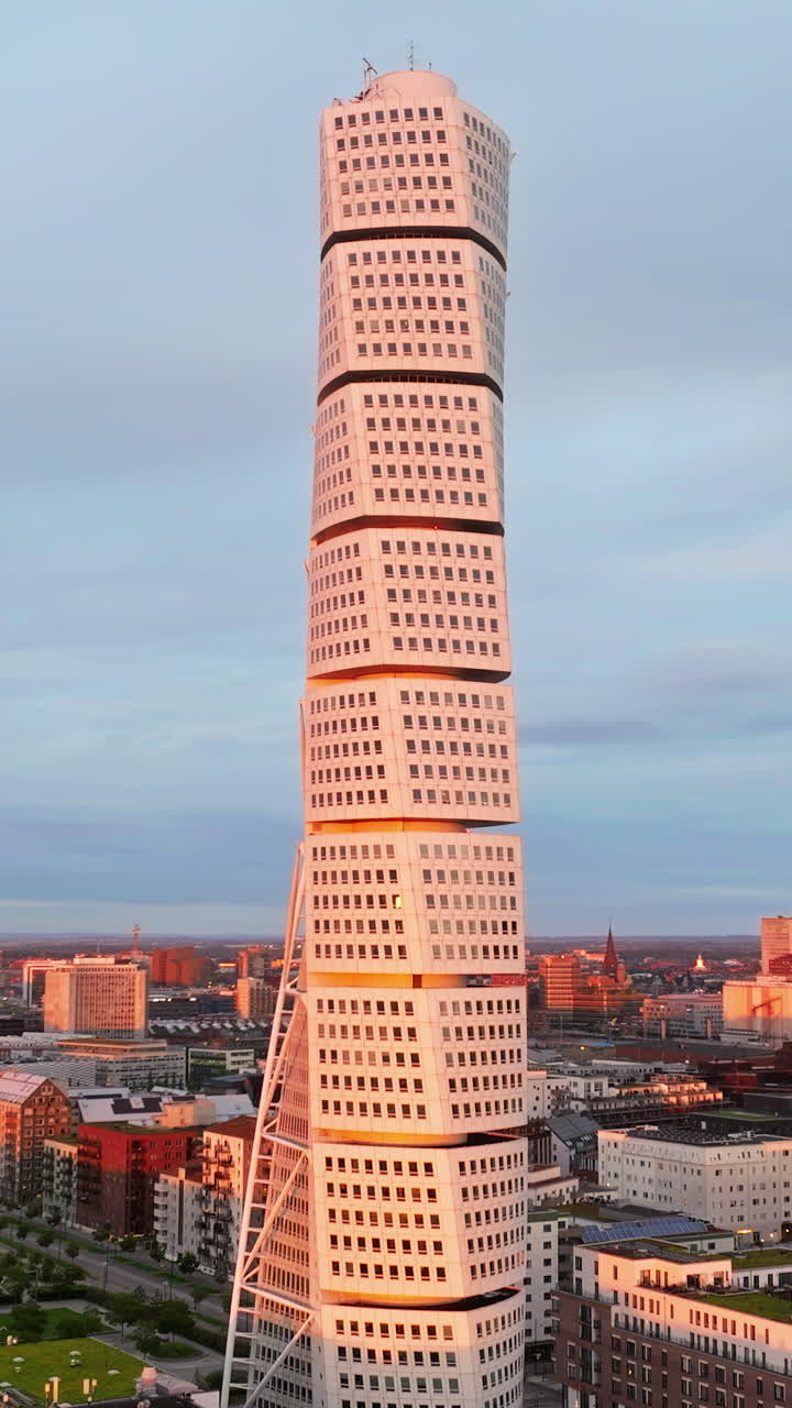 Aerial drone view of Turning Torso residential skyscraper in Malmo, Sweden at sunset. Vertical